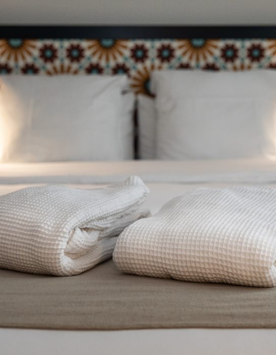 towels on a double bed in the cosy superior room - hotel saint nicolas