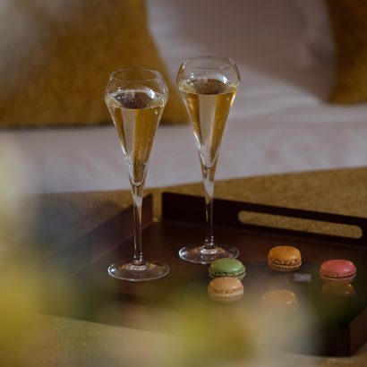 glass of champagne with macaron - hotel restaurant la rochelle